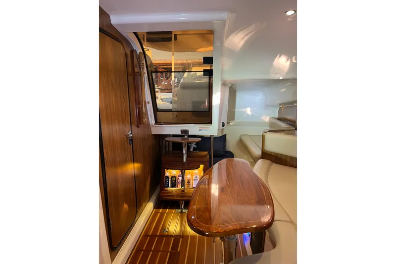 Slide: The Image of Luxurious interior of 2009 Pursuit OS 375 Offshore boat with wood accents and seating. - 23