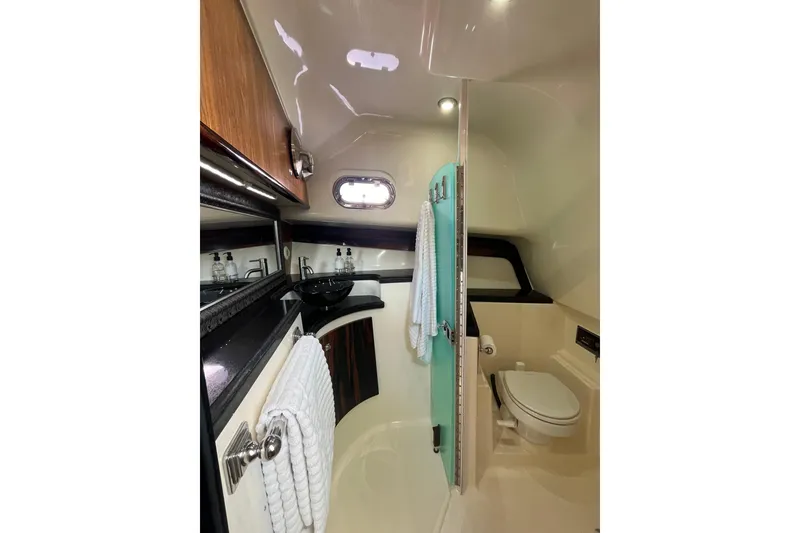 Slide: The Image of Luxurious bathroom interior of 2009 Pursuit OS 375 Offshore boat, featuring modern amenities. - 24