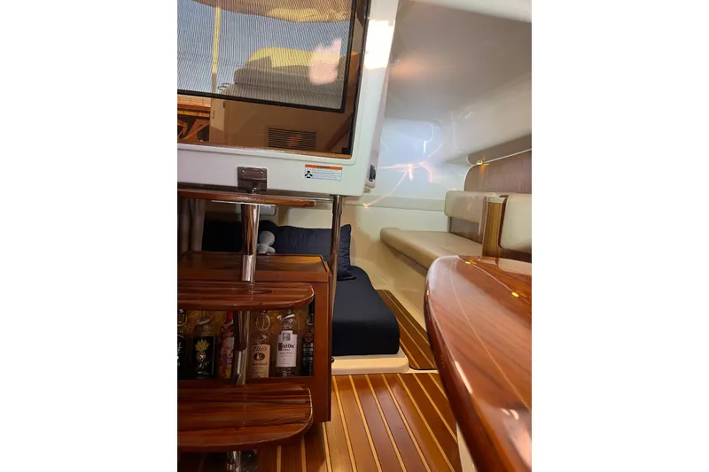 Slide: The Image of Luxurious interior of 2009 Pursuit OS 375 Offshore boat with wooden finishes and seating area. - 26