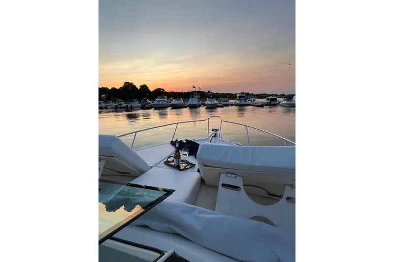 Slide: The Image of 2009 Pursuit OS 375 Offshore yacht at sunset with wine on deck. - 34