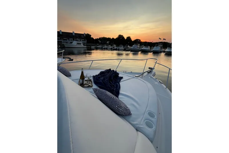 Slide: The Image of 2009 Pursuit OS 375 Offshore yacht at sunset with wine and pillows on deck. - 35