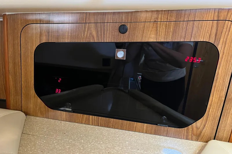 Slide: The Image of 2009 Pursuit OS 375 Offshore interior with digital display and wood paneling. - 39