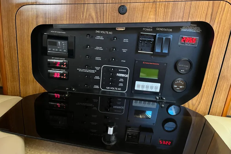 Slide: The Image of Control panel of a 2009 Pursuit OS 375 Offshore boat, featuring various switches and gauges. - 40