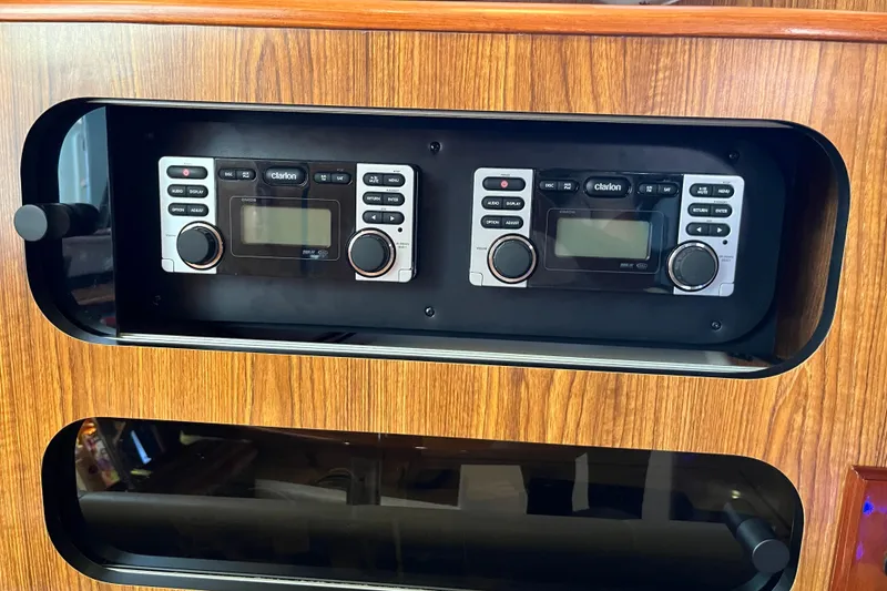 Slide: The Image of 2009 Pursuit OS 375 Offshore boat stereo system with dual Clarion units in wooden panel. - 41