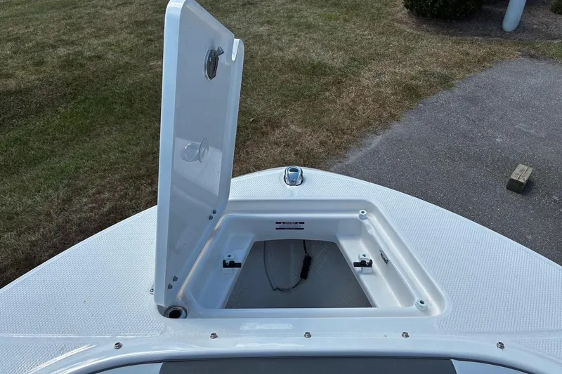 Slide: The Image of Open storage compartment on 2025 Robalo R207 Dual Console boat deck. - 12