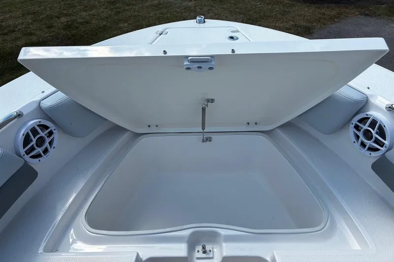 Slide: The Image of Open storage compartment on 2025 Robalo R207 Dual Console boat. - 13