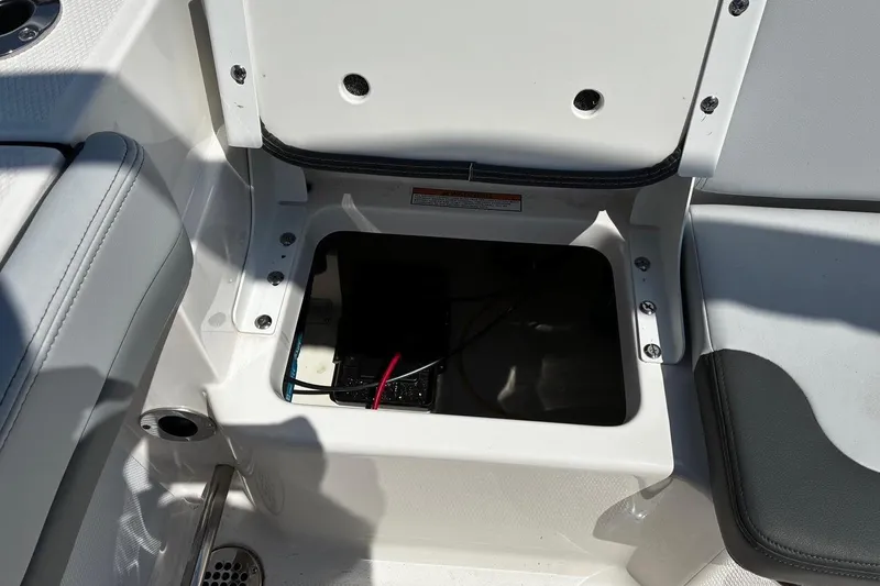 Slide: The Image of Open storage compartment on 2025 Robalo R207 Dual Console boat. - 19