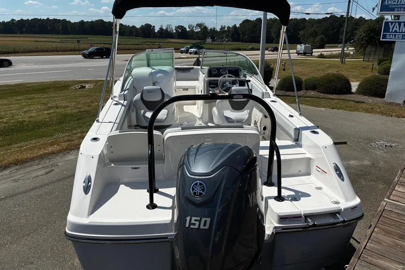 Slide: The Image of 2025 Robalo R207 Dual Console boat with Yamaha 150 engine, parked outdoors. - 3