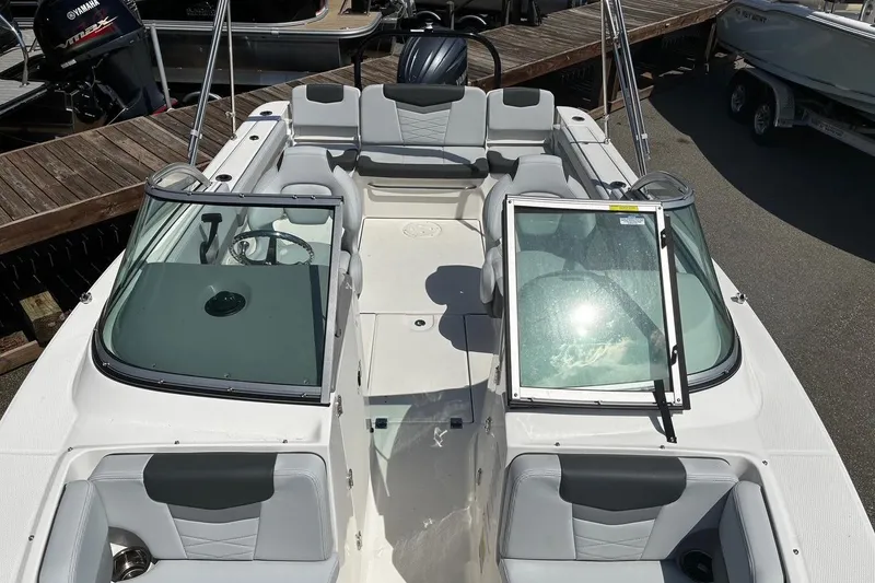 Slide: The Image of 2025 Robalo R207 Dual Console boat with open windshield, docked. - 5