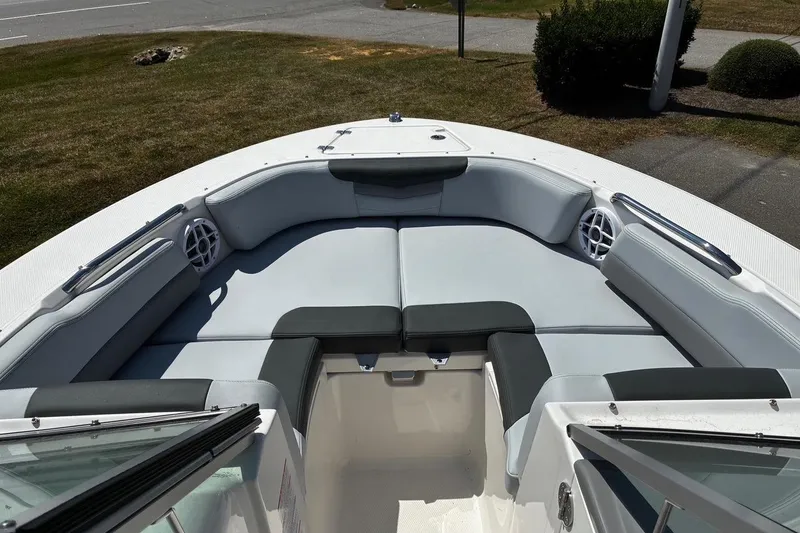Slide: The Image of 2025 Robalo R207 Dual Console boat interior with cushioned seating and speakers. - 7