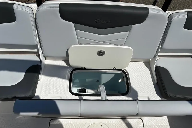 Slide: The Image of 2025 Robalo R207 Dual Console boat seating with storage compartment open. - 9