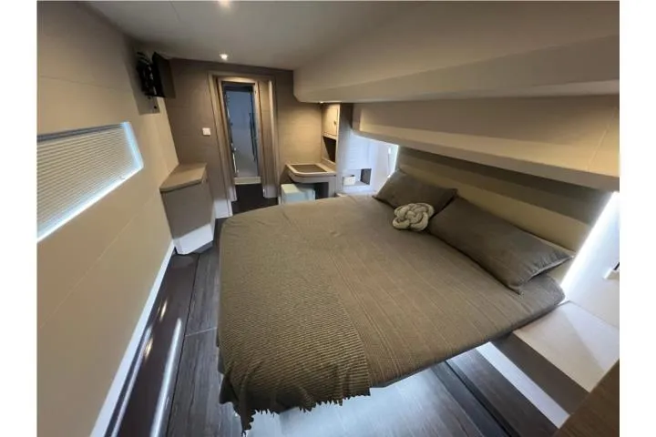 Slide: The Image of Luxurious bedroom interior of 2024 Fountaine Pajot MY6 yacht, featuring modern design and cozy bedding. - 15