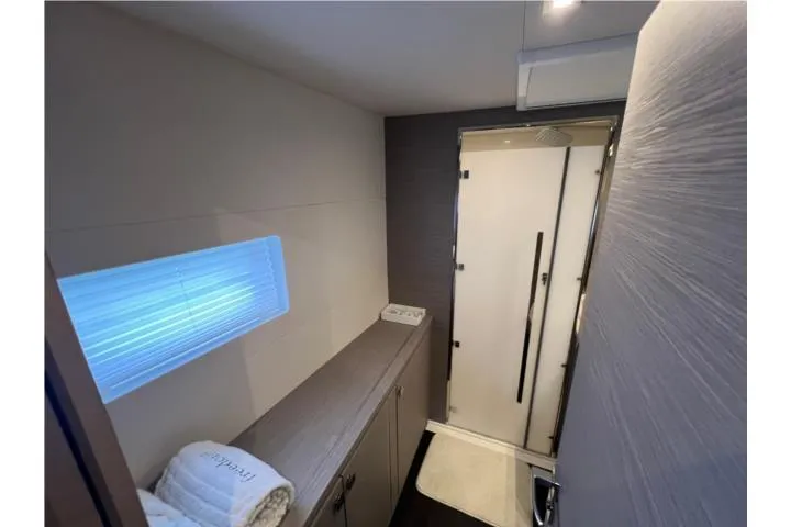 Slide: The Image of 2024 Fountaine Pajot MY6 yacht bathroom with modern shower and sleek cabinetry. - 16