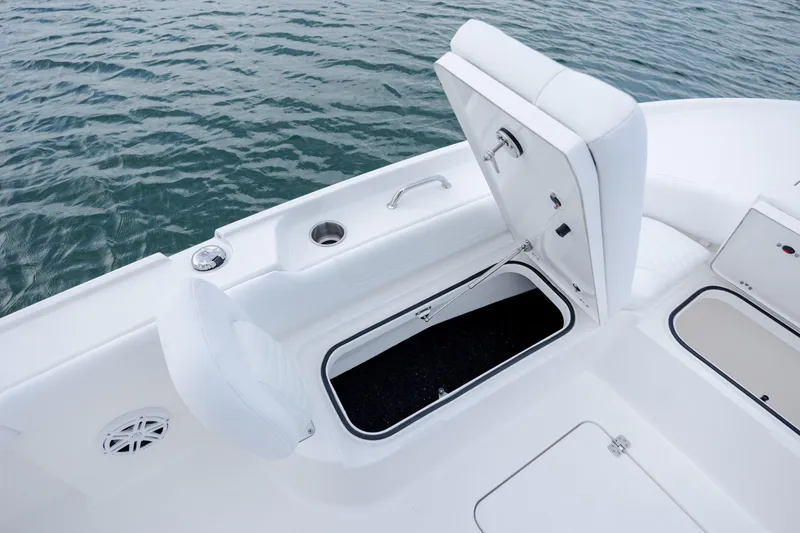 Slide: The Image of Caymas 24 HB 2026 boat with open storage compartment on deck. - 13