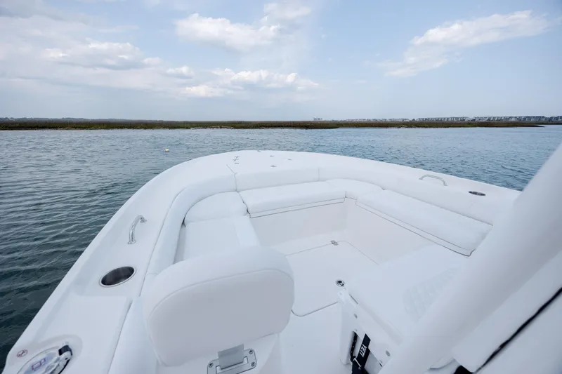 Slide: The Image of 2026 Caymas 24 HB boat on calm water. - 16