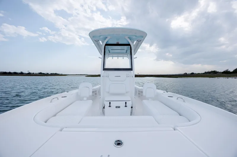 Slide: The Image of Caymas 24 HB 2026 boat on calm water under cloudy sky. - 17