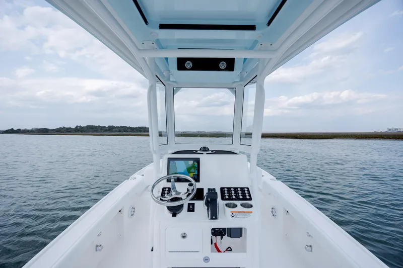 Slide: The Image of Interior view of 2026 Caymas 24 HB boat on water. - 19