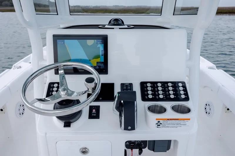 Slide: The Image of 2026 Caymas 24 HB helm with navigation system and controls. - 20