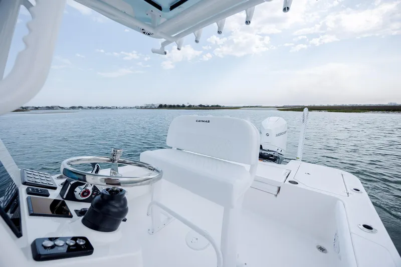 Slide: The Image of Caymas 24 HB 2026 boat on calm water with clear view. - 23