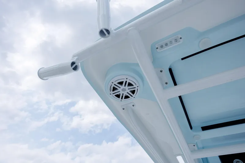 Slide: The Image of Caymas 24 HB 2026 boat roof with speaker and sky view. - 24