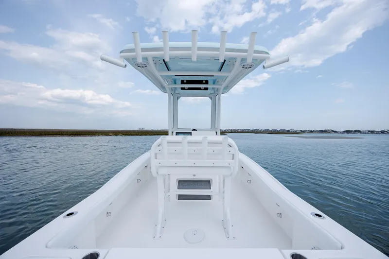 Slide: The Image of Caymas 24 HB 2026 boat on calm water with blue sky. - 29