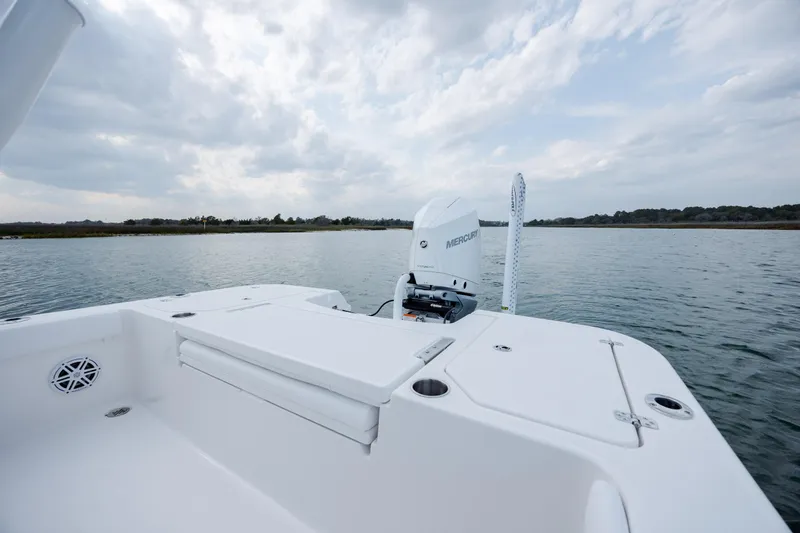 Slide: The Image of Caymas 24 HB 2026 boat on calm water with Mercury engine. - 30