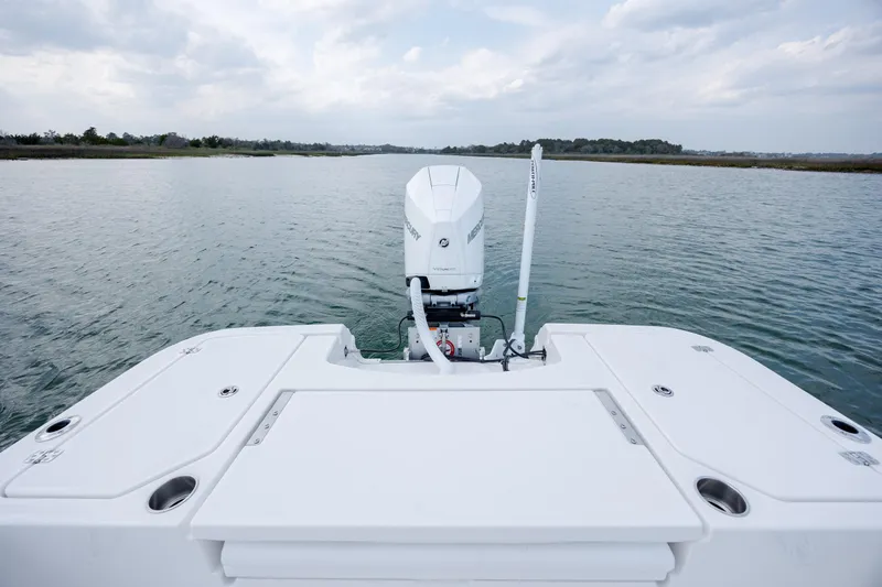 Slide: The Image of Rear view of Caymas 24 HB boat on open water. - 32