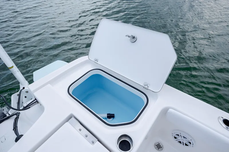 Slide: The Image of Open storage compartment on a 2026 Caymas 24 HB boat. - 34