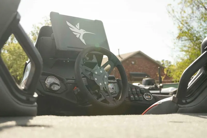 Slide: The Image of Steering console of 2026 Skeeter ZXE20 boat with digital display and controls. - 13