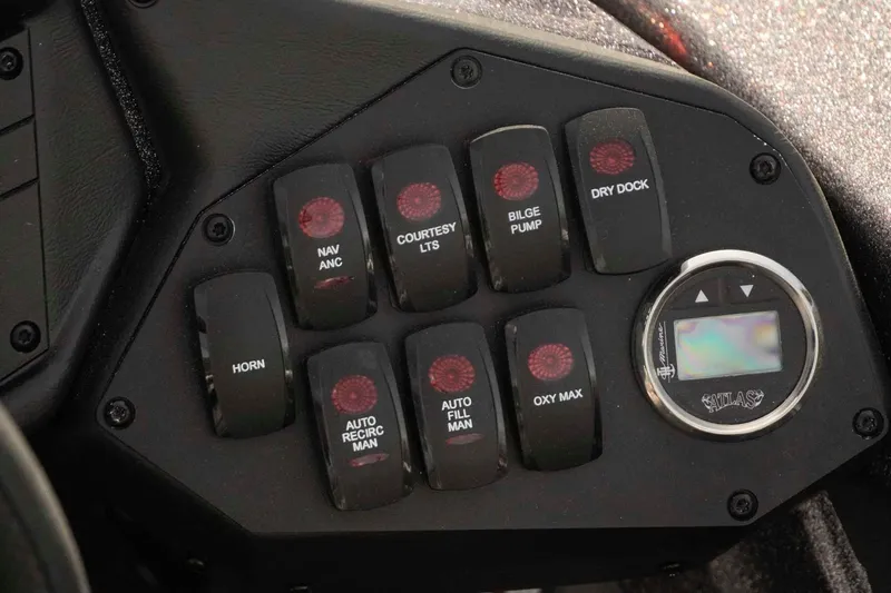 Slide: The Image of Control panel of 2026 Skeeter ZXE20 boat with various switches and digital display. - 14