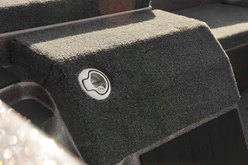 Slide: The Image of 2026 Skeeter ZXE20 boat deck with textured surface and metal latch detail. - 36