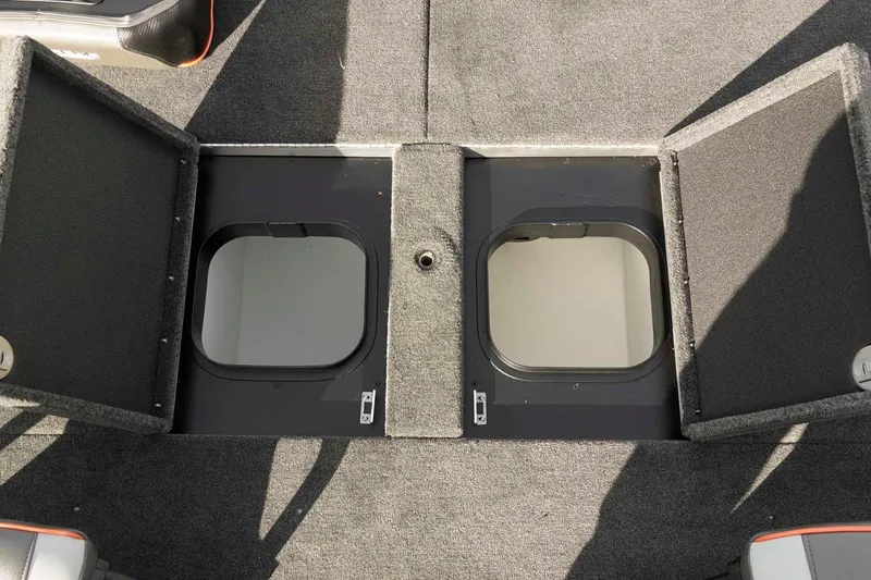 Slide: The Image of Open storage compartments on a 2026 Skeeter ZXE20 boat deck. - 37