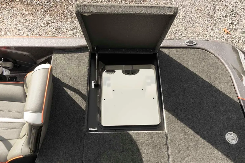Slide: The Image of 2026 Skeeter ZXE20 boat storage compartment with open hatch and seating area. - 41