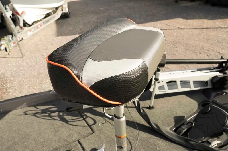 Slide: The Image of Skeeter ZXE20 2026 boat seat with black and orange accents on a fishing deck. - 42