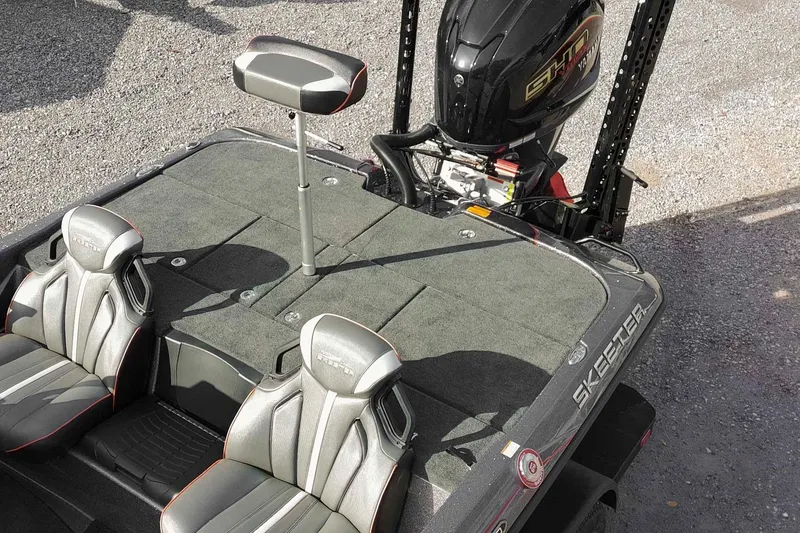 Slide: The Image of 2026 Skeeter ZXE20 boat interior with dual seats and motor, showcasing sleek design. - 44