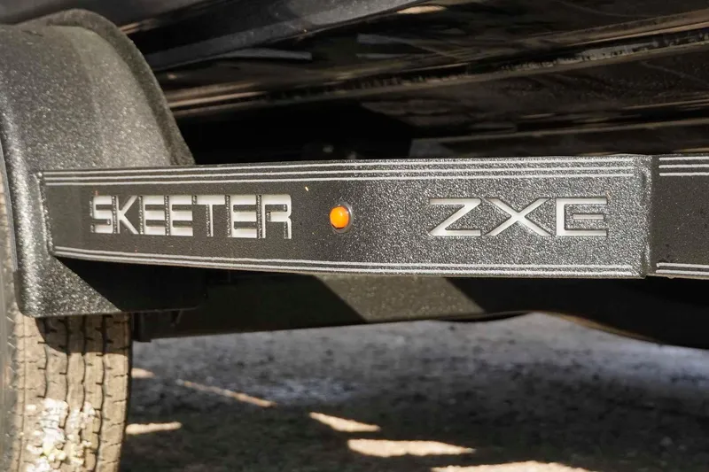 Slide: The Image of 2026 Skeeter ZXE20 trailer detail with logo and orange reflector. - 47