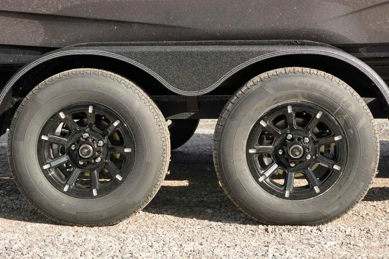 Slide: The Image of Trailer wheels of a 2026 Skeeter ZXE20 on gravel surface. - 48