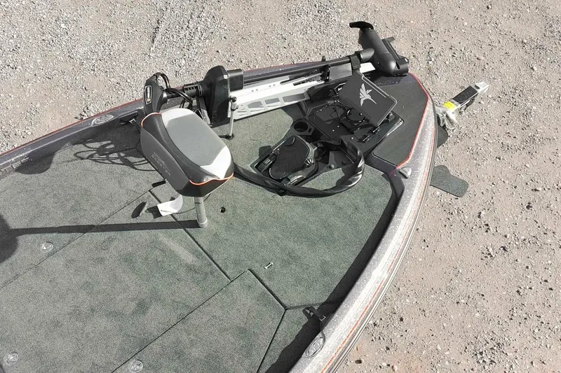 Slide: The Image of 2026 Skeeter ZXE20 boat deck with fishing seat and equipment, on gravel surface. - 5
