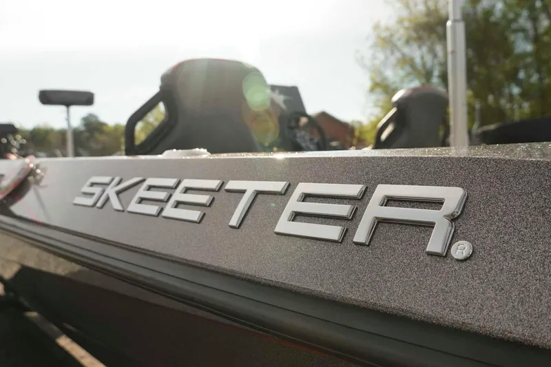 Slide: The Image of 2026 Skeeter ZXE20 boat with logo, sunlight reflecting on metallic surface. - 50