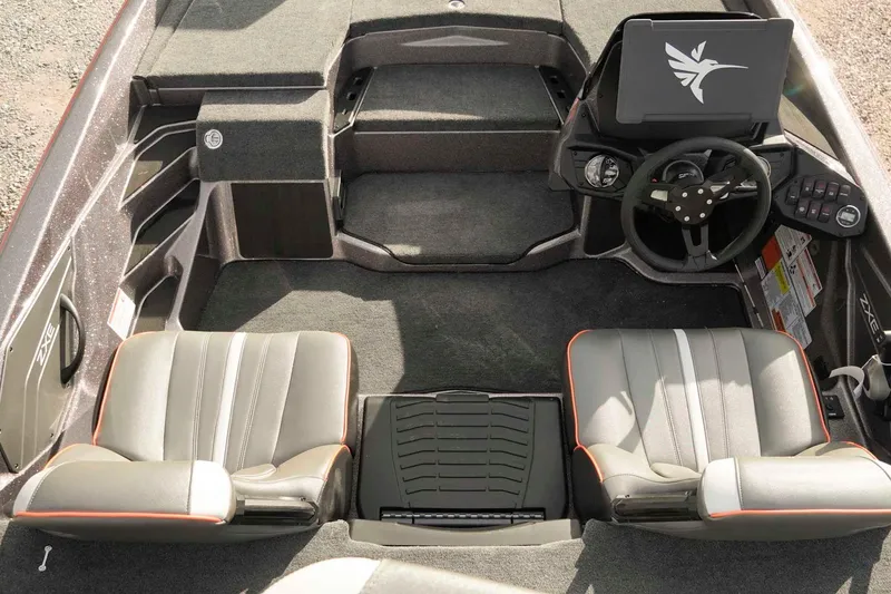 Slide: The Image of 2026 Skeeter ZXE20 boat interior with dual seats, steering console, and carpeted flooring. - 9