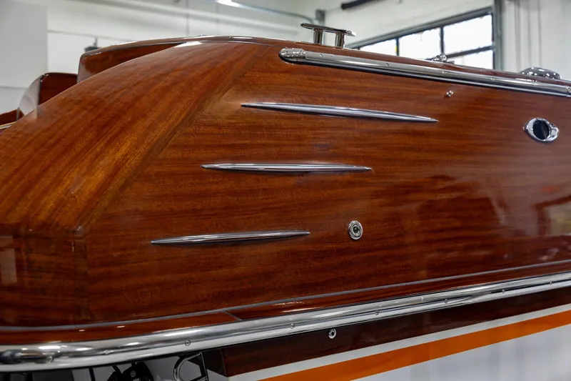 Slide: The Image of 2025 Comitti Venezia V28 boat with polished wooden finish and sleek chrome accents. - 16