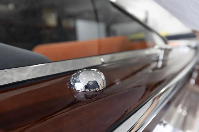 Slide: The Image of Close-up of 2025 Comitti Venezia V28 boat's polished wooden deck and chrome detail. - 19