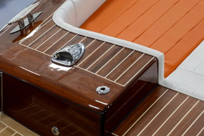 Slide: The Image of 2025 Comitti Venezia V28 boat with orange and white seating, polished wood finish. - 3