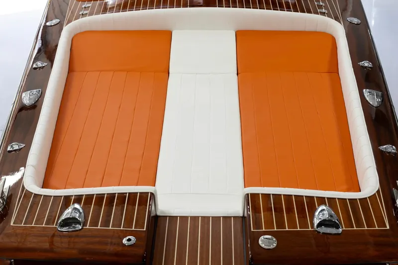 Slide: The Image of 2025 Comitti Venezia V28 boat with orange and white cushioned seating. - 4