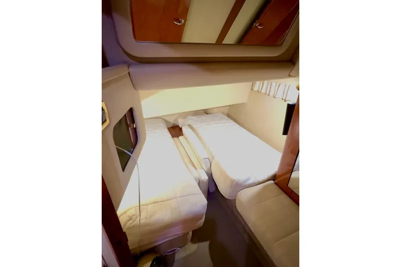 Slide: The Image of 2001 Sea Ray 400 Sedan Bridge cabin with twin beds and cozy interior. - 10