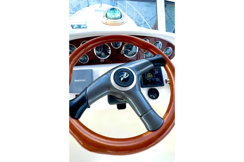 Slide: The Image of Helm of 2001 Sea Ray 400 Sedan Bridge with wooden steering wheel and navigation instruments. - 12