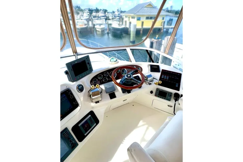 Slide: The Image of Cockpit of 2001 Sea Ray 400 Sedan Bridge with marina view. - 13
