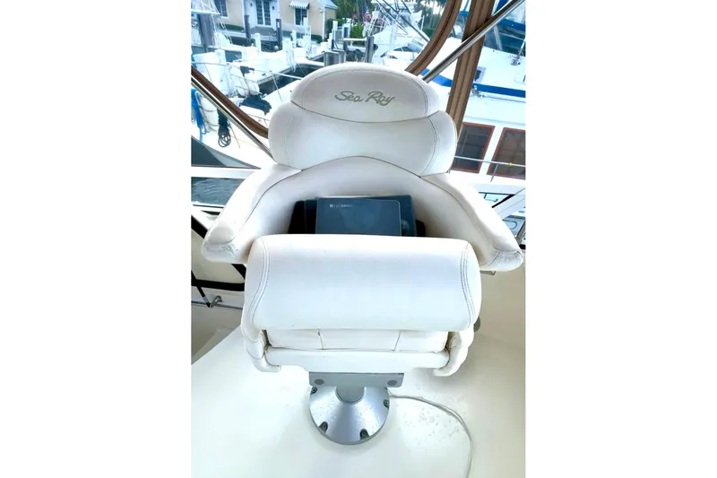 Slide: The Image of Captain's chair on 2001 Sea Ray 400 Sedan Bridge yacht, overlooking marina. - 14