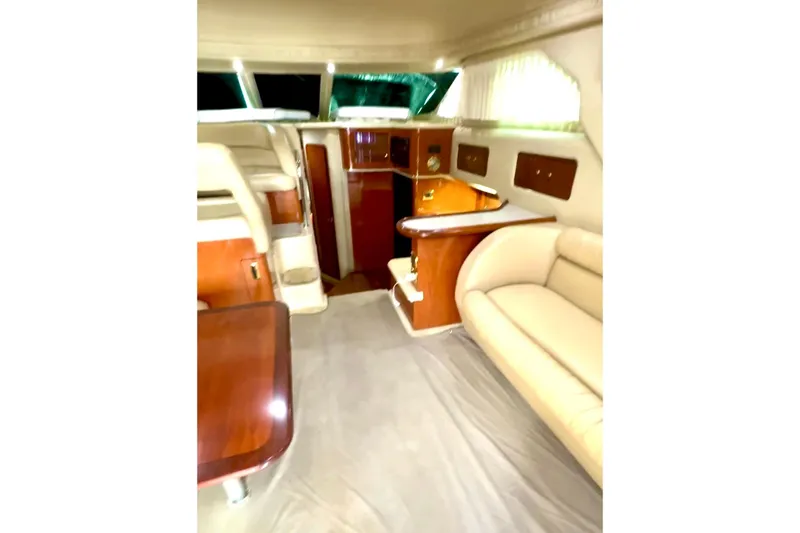 Slide: The Image of Luxurious interior of 2001 Sea Ray 400 Sedan Bridge yacht with elegant seating and wood finishes. - 3