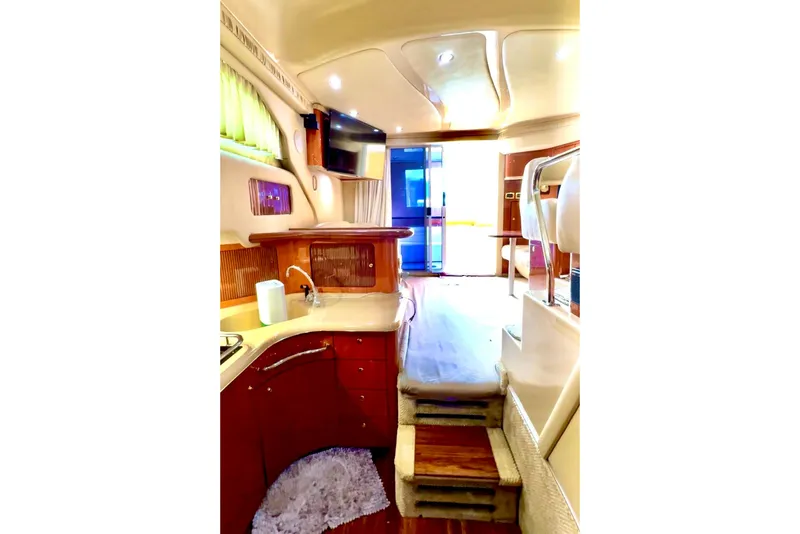 Slide: The Image of Interior of 2001 Sea Ray 400 Sedan Bridge yacht, featuring a cozy cabin and modern amenities. - 6